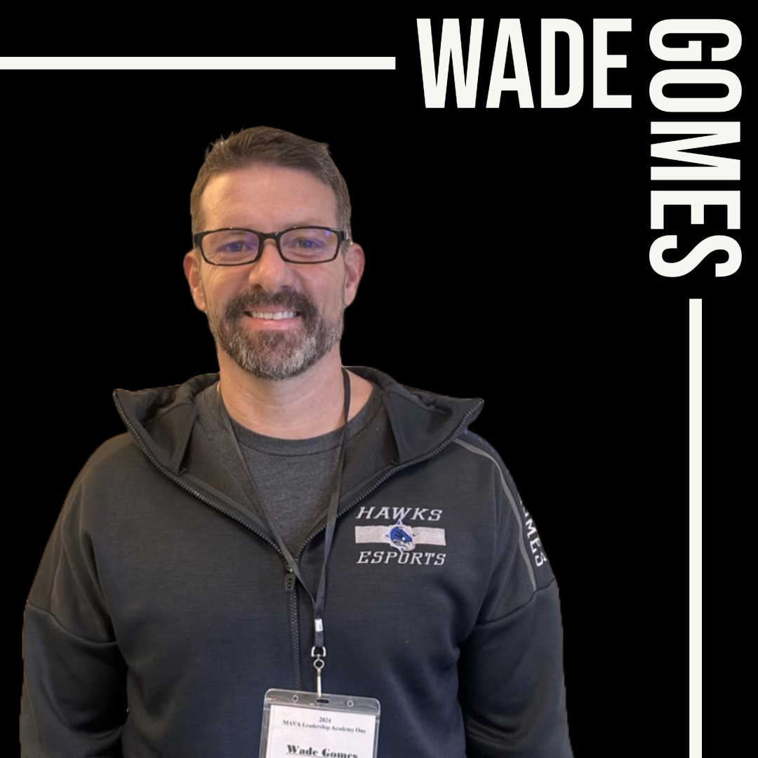 This is a photo of Wade Gomes smiling and wearing glasses.